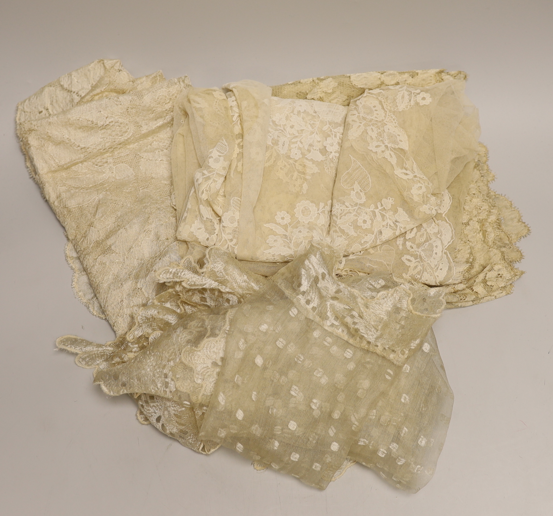 An Irish needle run 19th century lace veil, a machine lace ‘Blonde’ veil and two later cream silk lace stoles